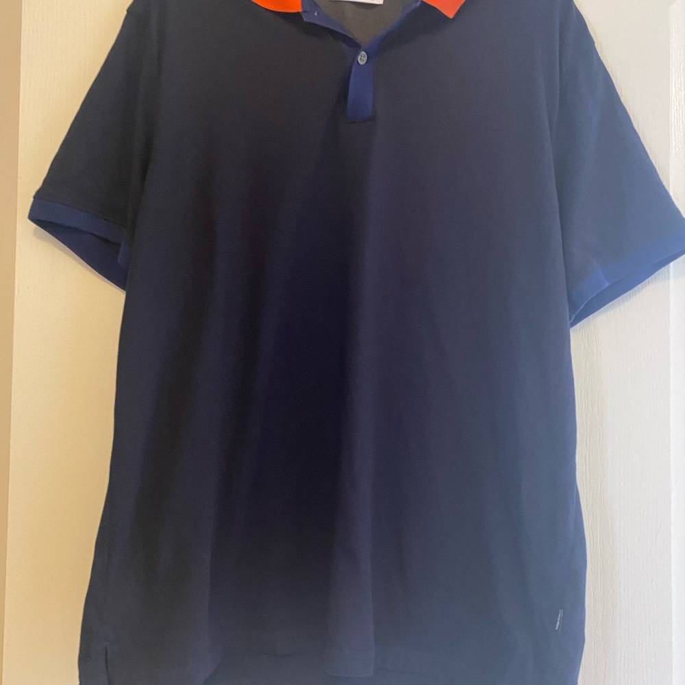 Lacoste men polo shirt . Blue with orange collar. Used . Good condition